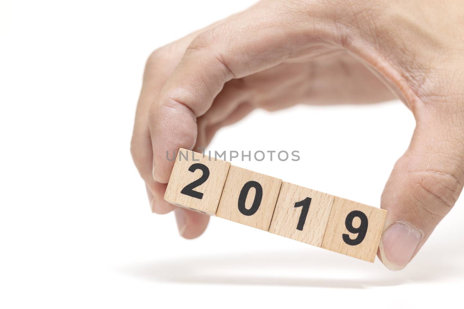 Hand holding wooden block 2019 on white background , Happy new year concept