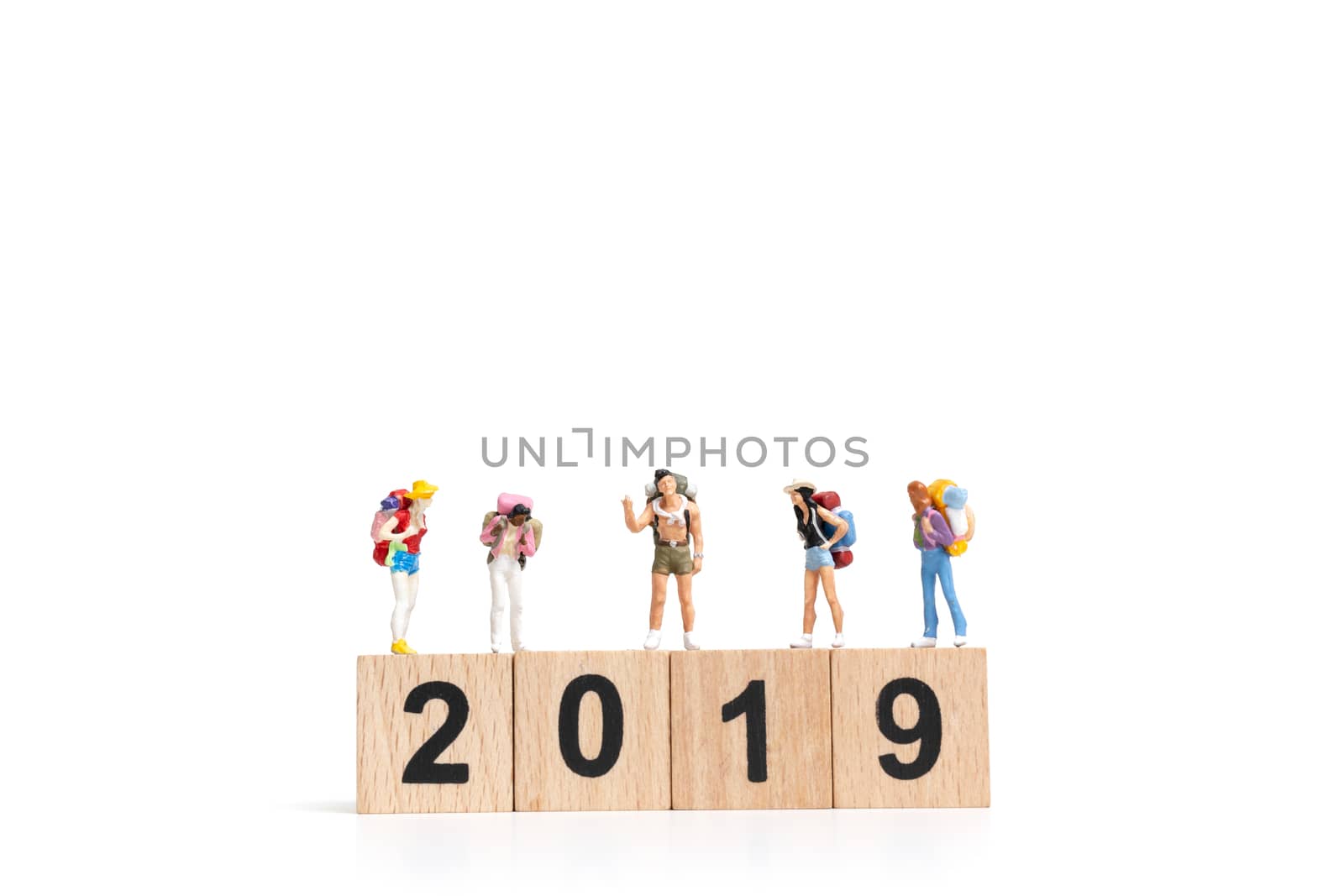 Miniature people Backpacker  on wooden block number 2019. isolated on white background