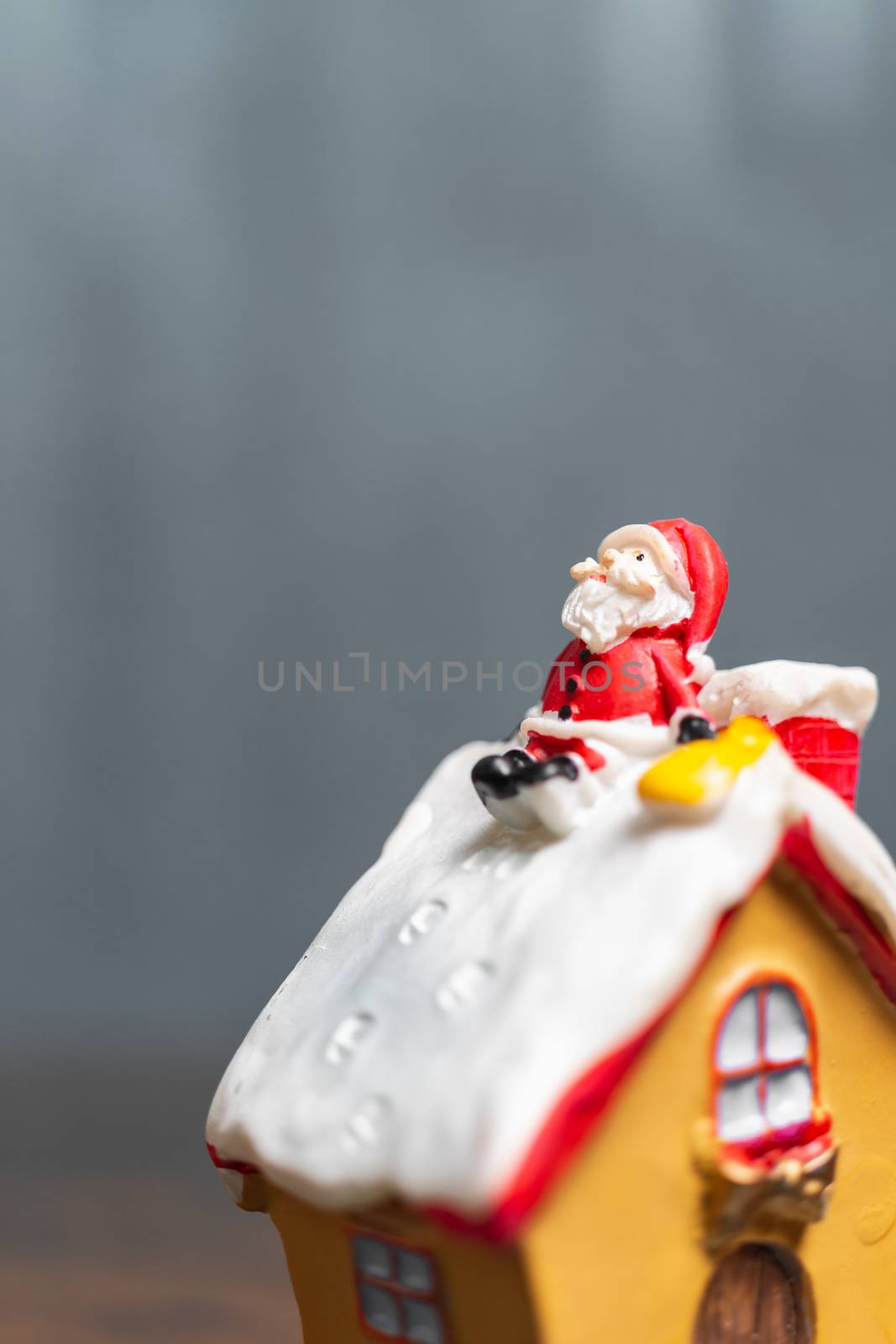 Merry Christmas and happy holidays! Cute Santa Claus sitting on the roof, Christmas legend concept.