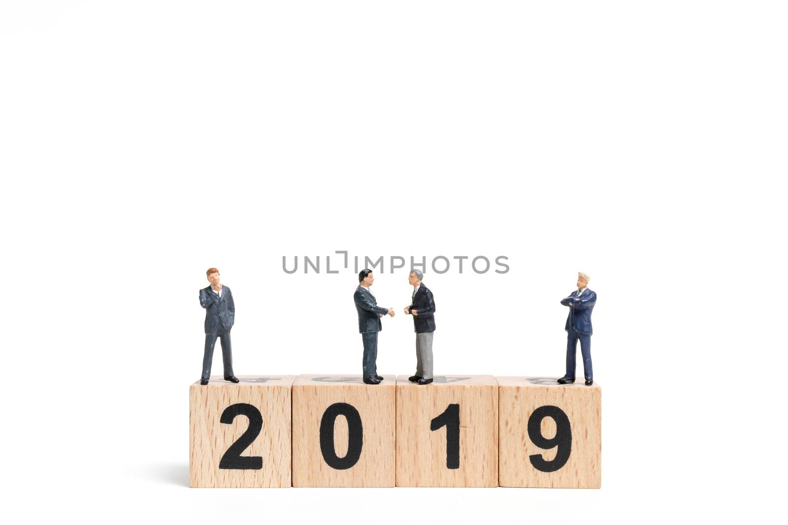Miniature people : businessman  standing and thinking on wooden block number 2019. on white background