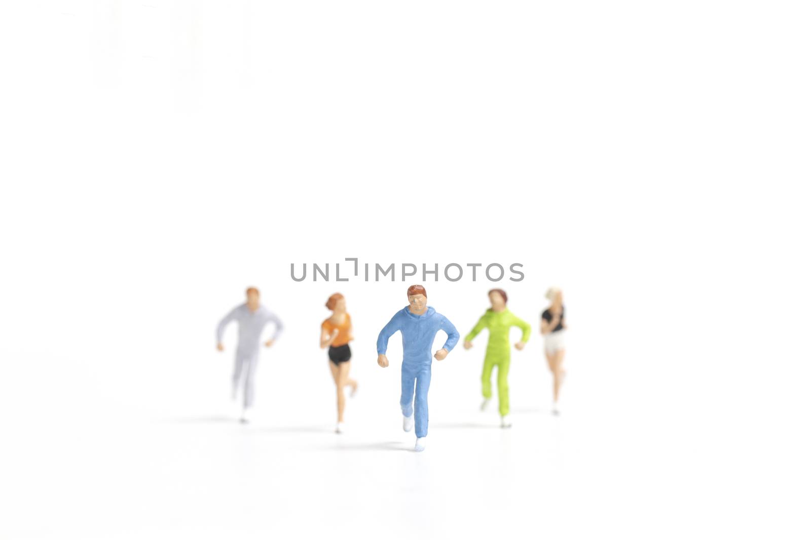 Miniature people running on white background , Healthy lifestyle and sport concepts. by sirichaiyaymicro