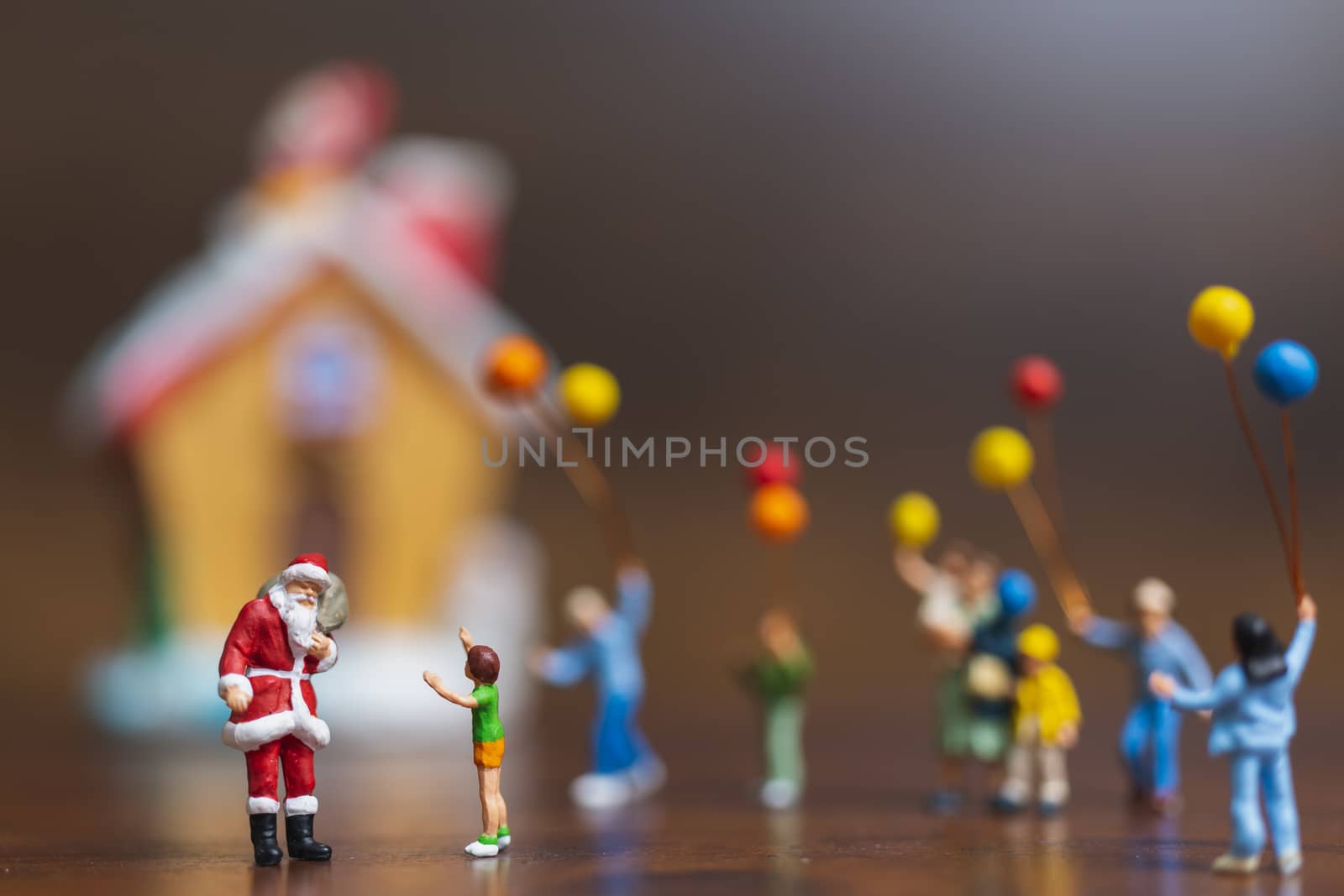 Miniature people: Santa Claus and children holding balloon , Merry Christmas and Happy New Year concept.