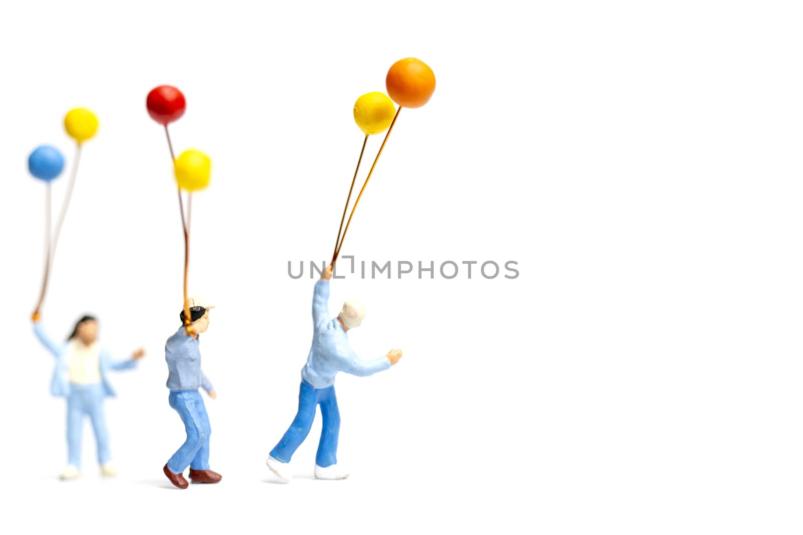 Miniature people : Children holding balloon on white background