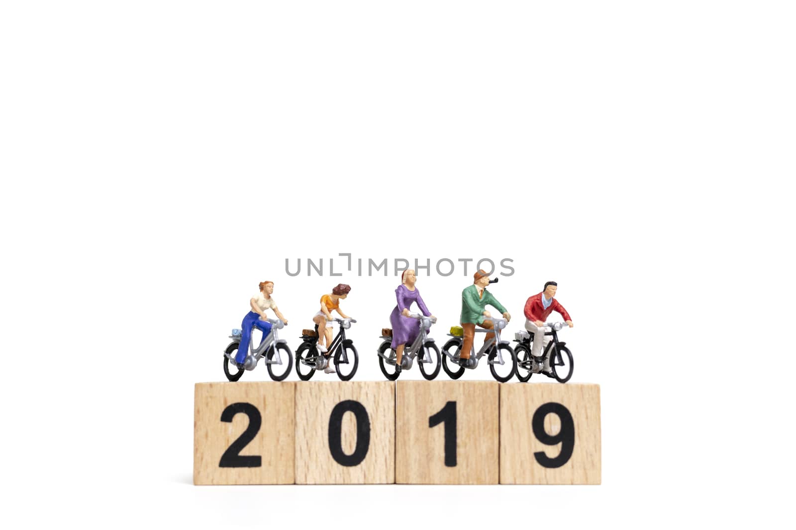 Miniature people : Friend Group ride bicycle with wooden number  2019 , Happy New Year  concept.