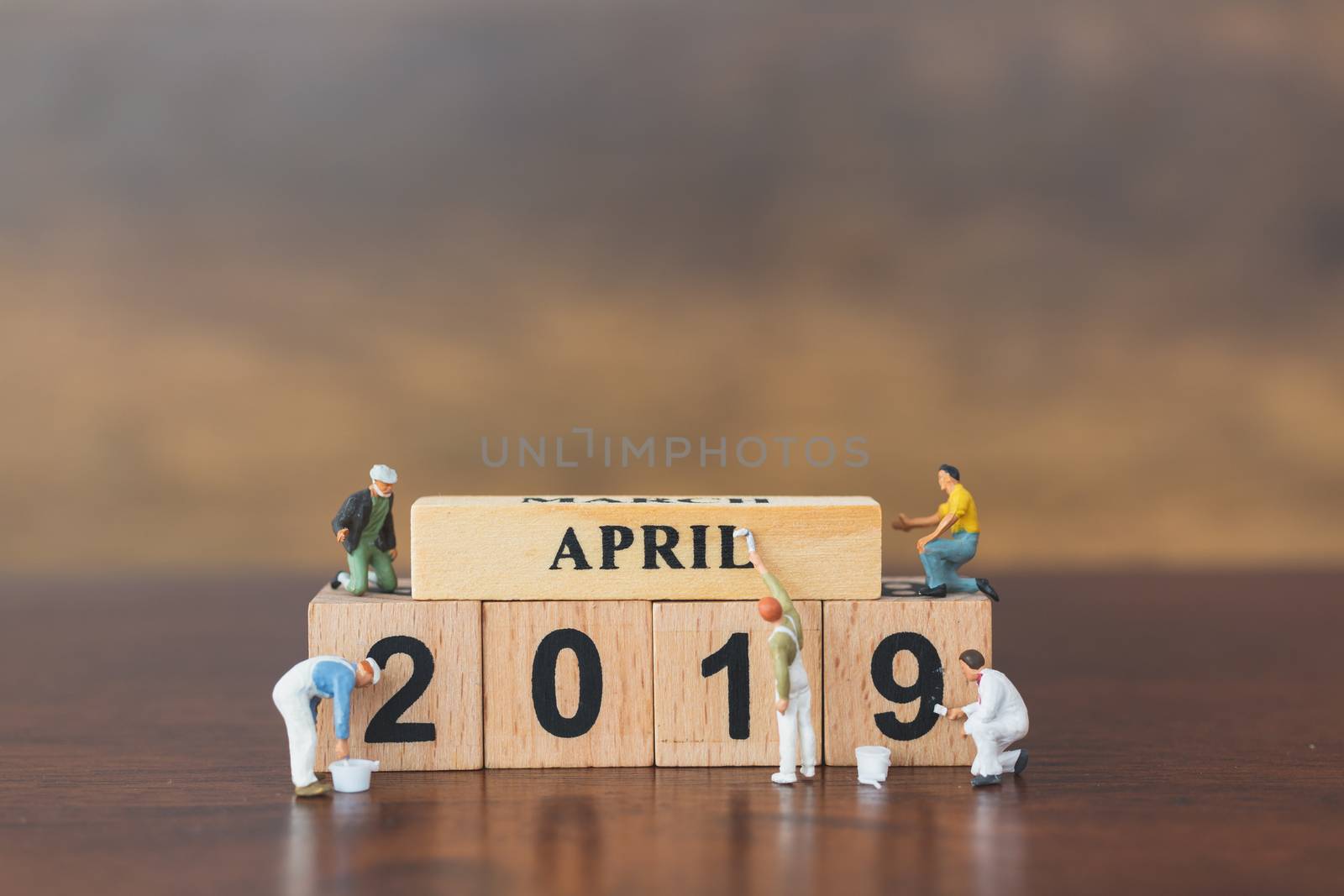 Miniature worker team painting  on wooden block , Happy new year 2019 concept