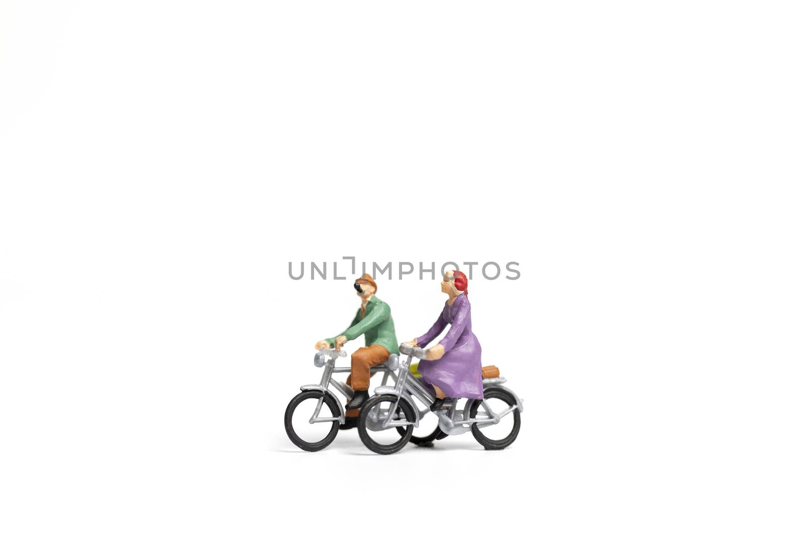 Miniature people : Couple ride bicycle on white background , Valentine's Day concept