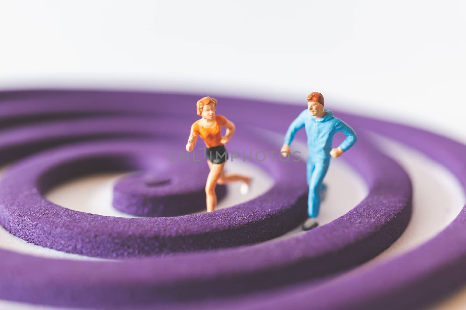 Miniature people : Couple Runnig on the purple field , Valentine's Day concept