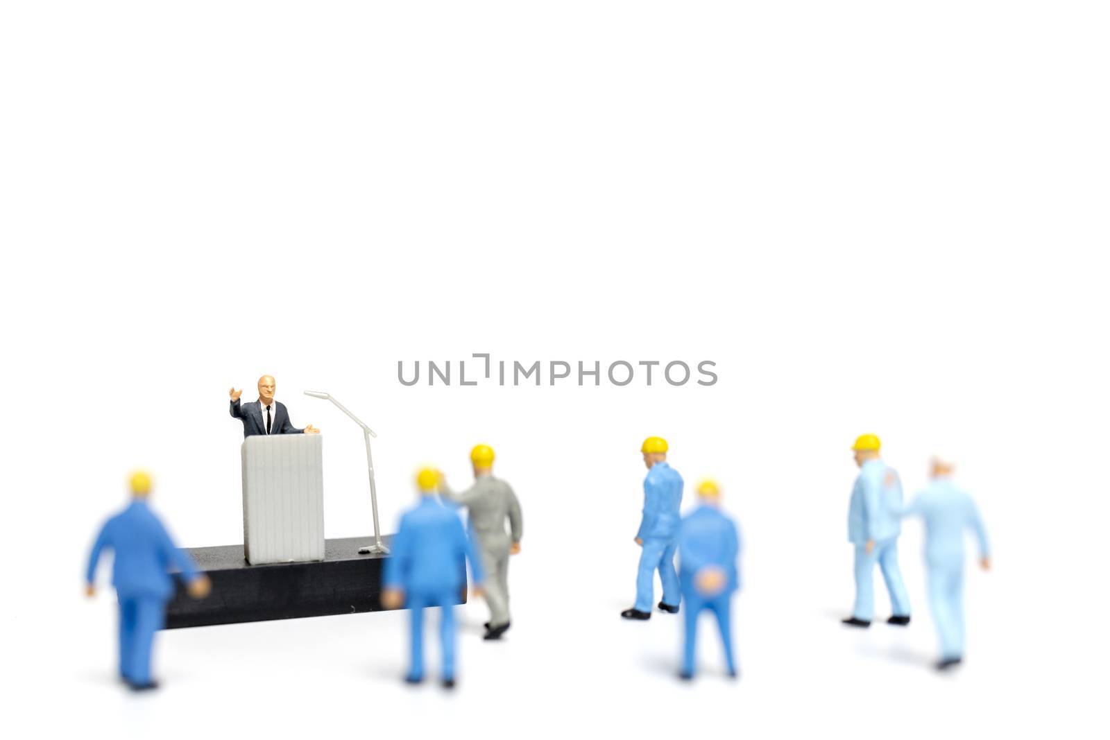 Miniature people : a politician speaking to the people during an election rally 