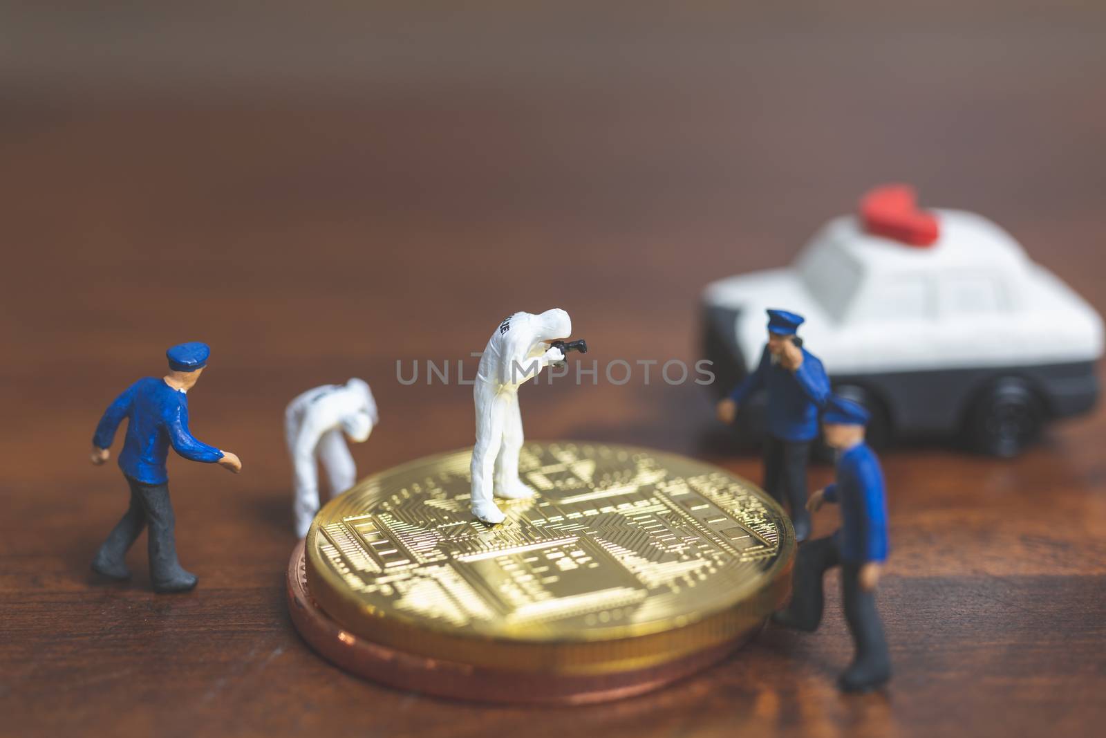 Miniature people : Police And Detective standing in front of Cryptocurrency bitcoin , Cyber crimes concept