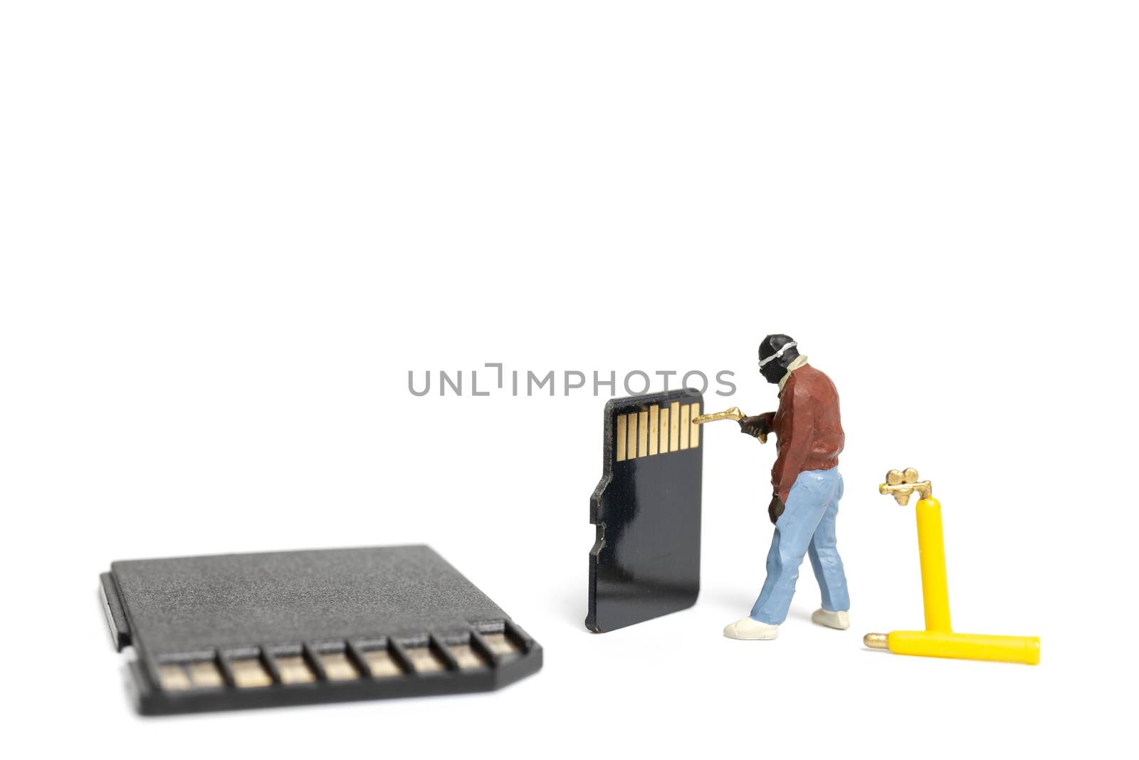 Miniature people technician fixing pile of sd cards on white background with copy space.