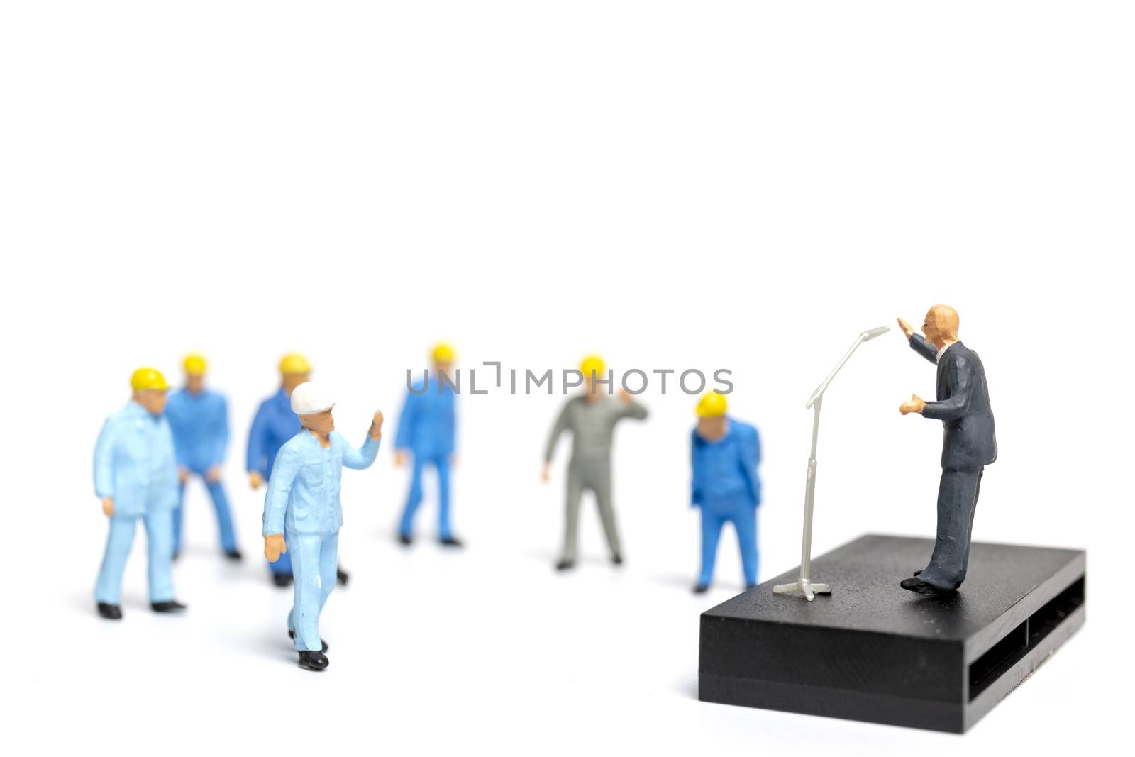 Miniature people : A politician speaking to the people during an election rally 