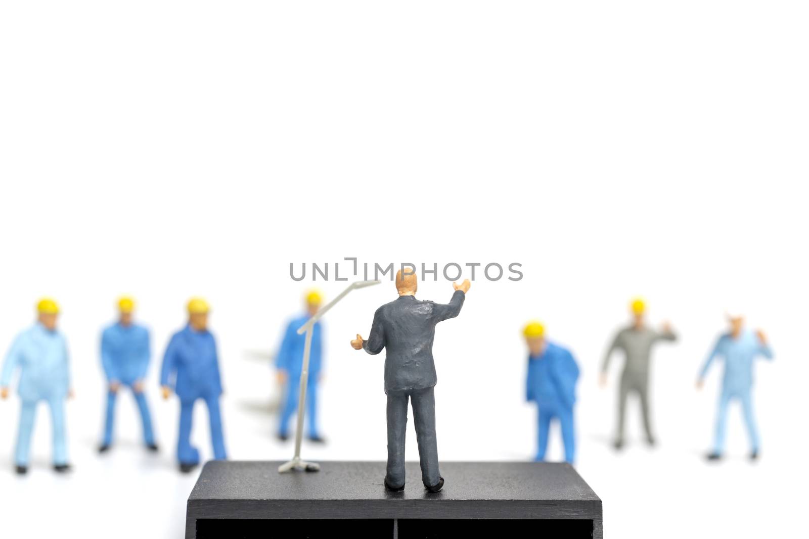 Miniature people : A politician speaking to the people during an election rally 