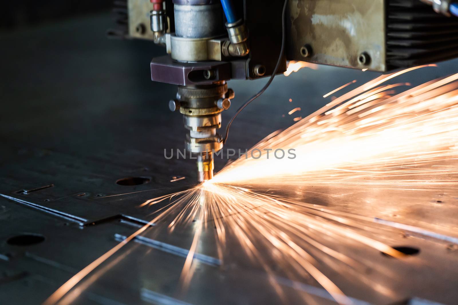 laser cutting process with a sheaf of sparks and motion blur of head unit while piercing through zinc plated steel sheet by z1b