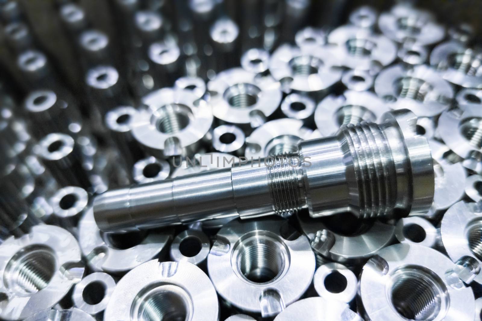 Shiny steel parts close-up background, long clean steel rods after fine cnc turning.