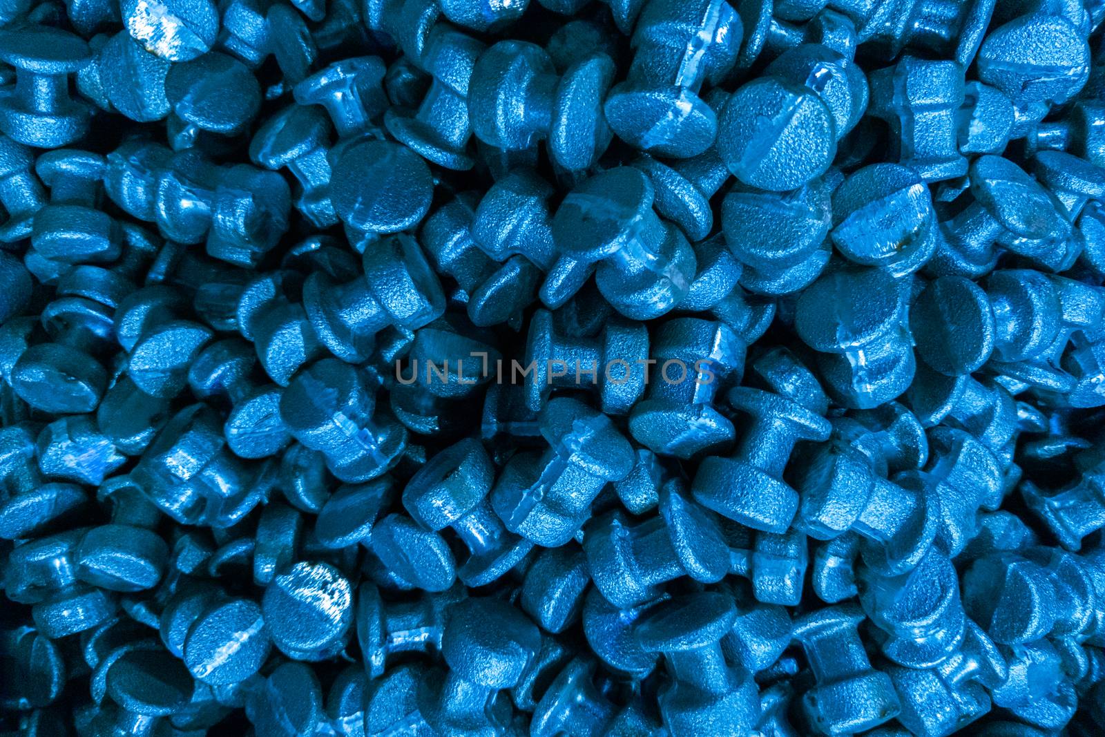 An abstract industrial full frame background of forged and sanded steel billets. Classic blue color toned backdrop.. Close-up with selective focus and optical blur.
