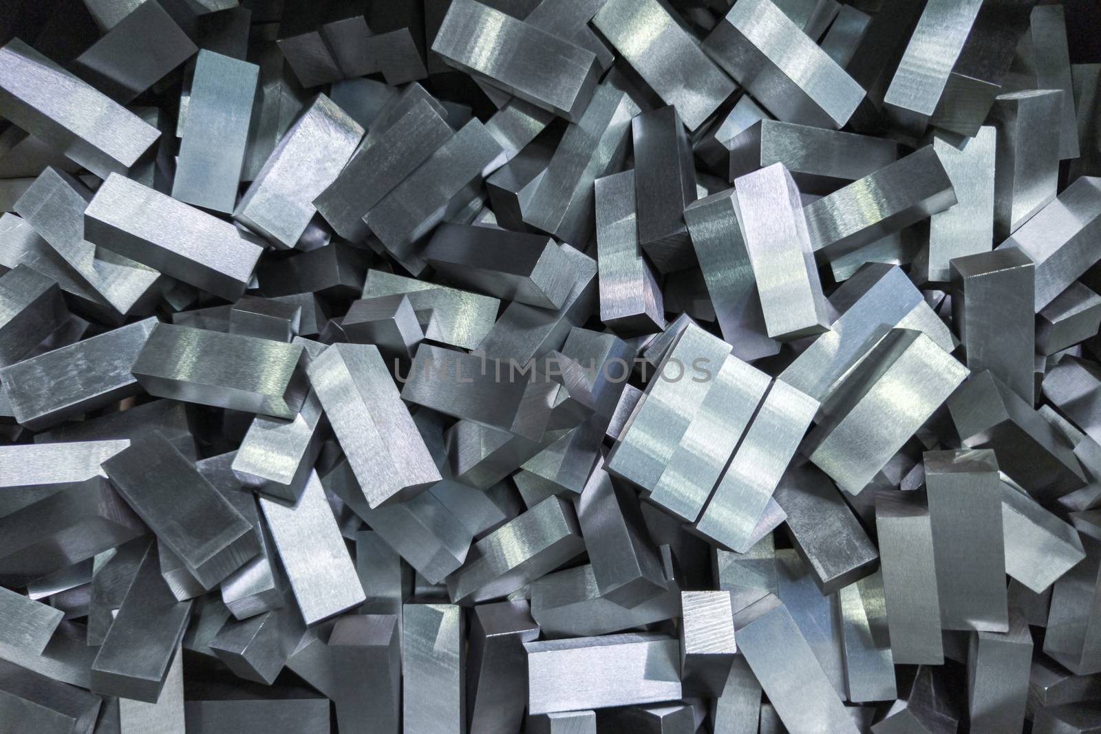 a pile of shiny faceted steel blocks - full frame close-up with selective focus, view directly from above