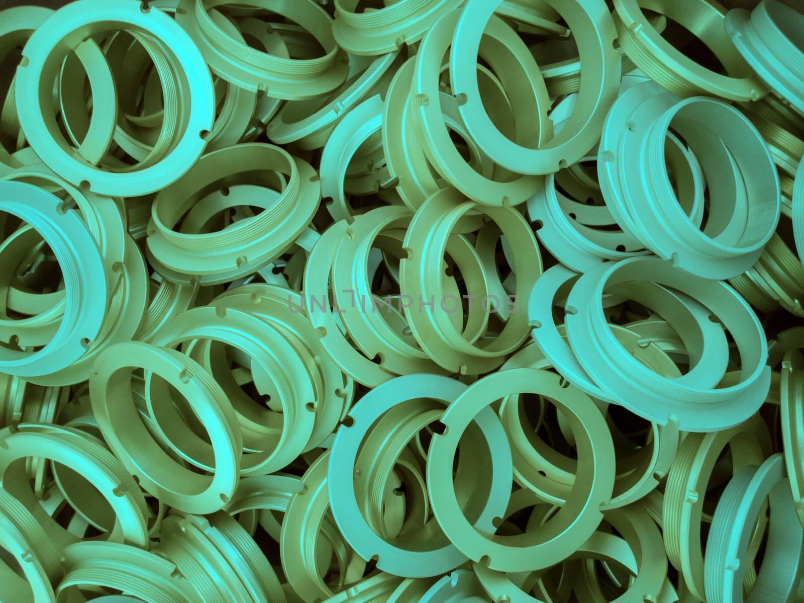 an abstract background of aqua menthe color coated metal ring parts.