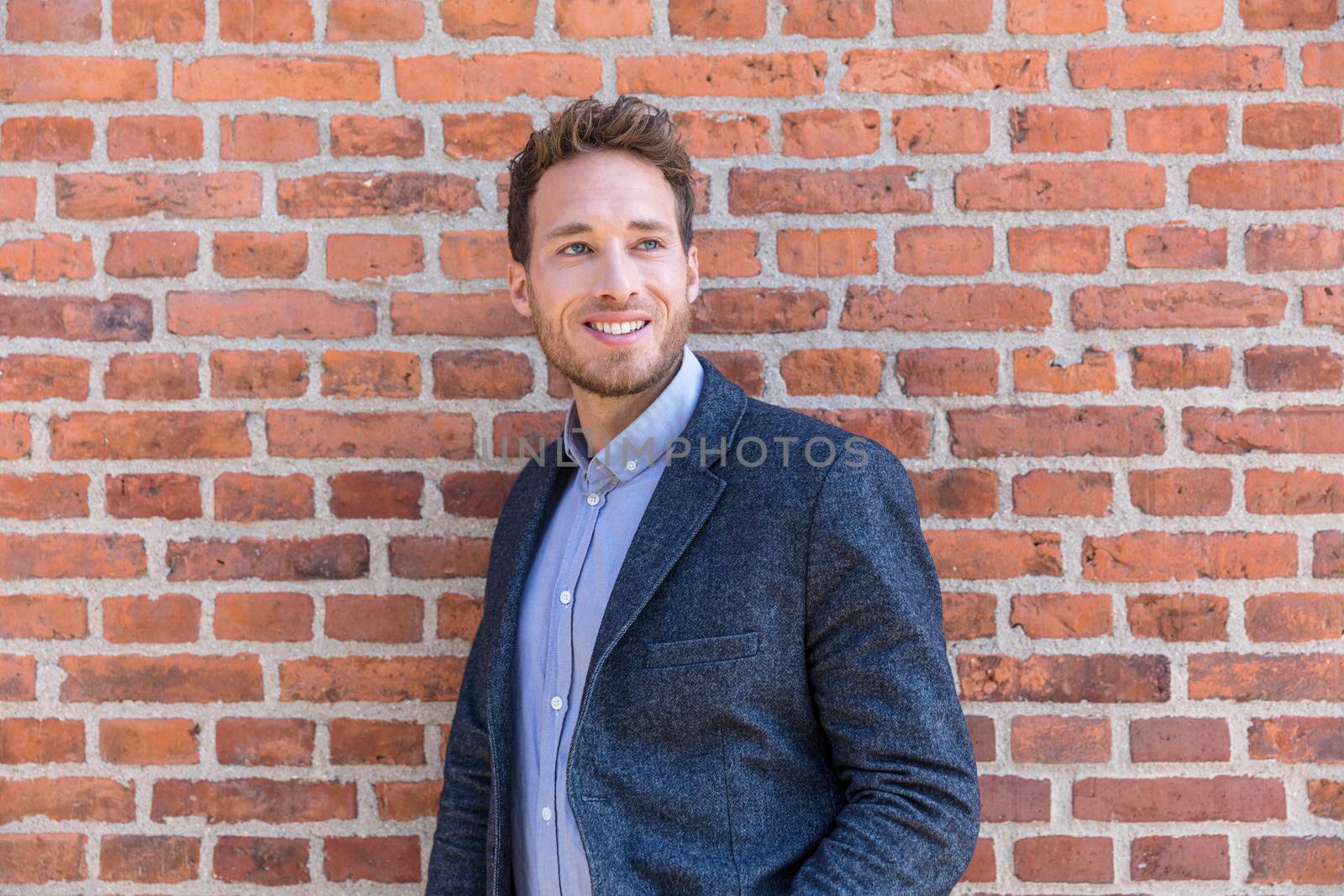 Man professional businessman portrait. Smart casual urban business man smiling happy at office building or city street. Handsome man wearing suit jacket indoors by Maridav