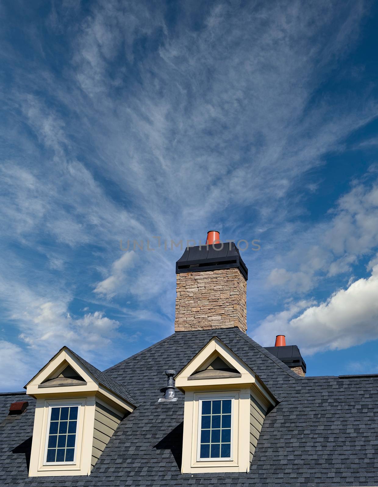 Dormers and Stone Chimney on House with Copy Space