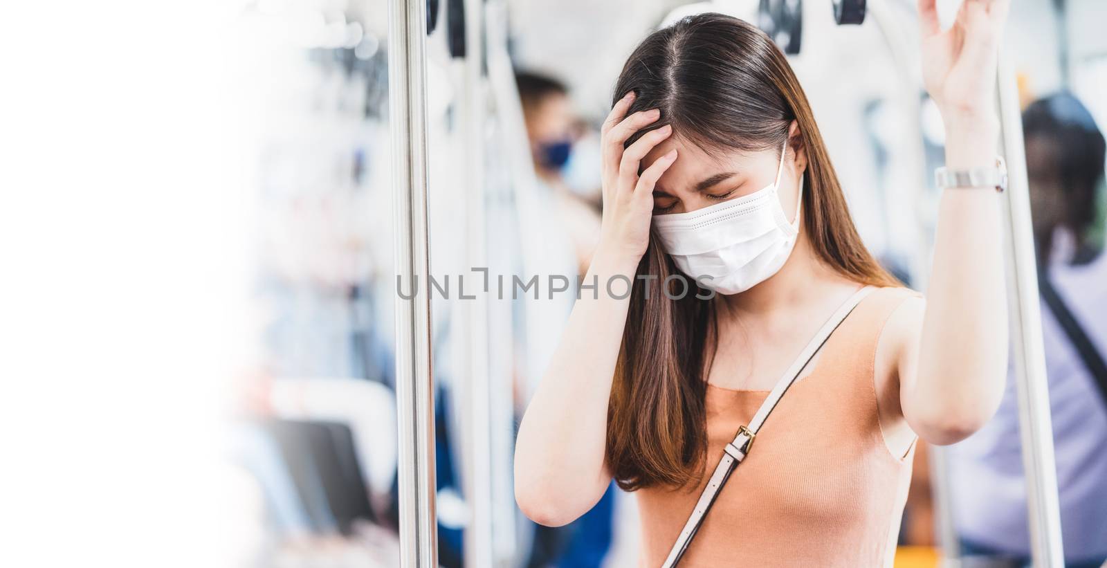 Young Asian woman passenger wearing surgical mask and Having a h by Tzido