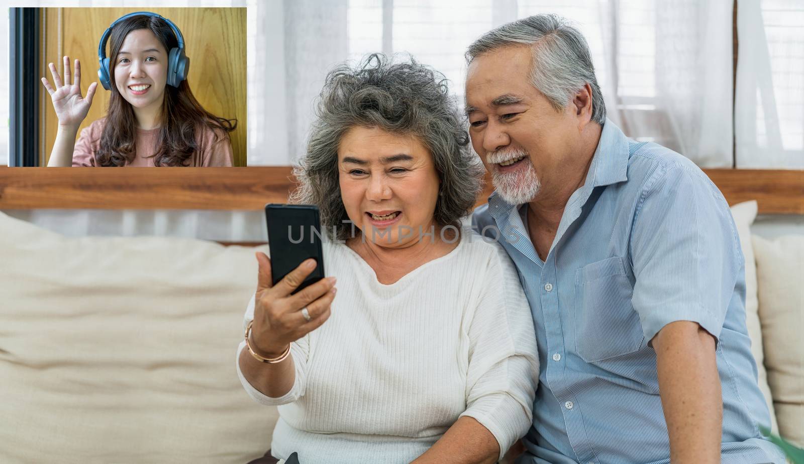 Asian couple Grandparent taking Video call to grandchild woman w by Tzido