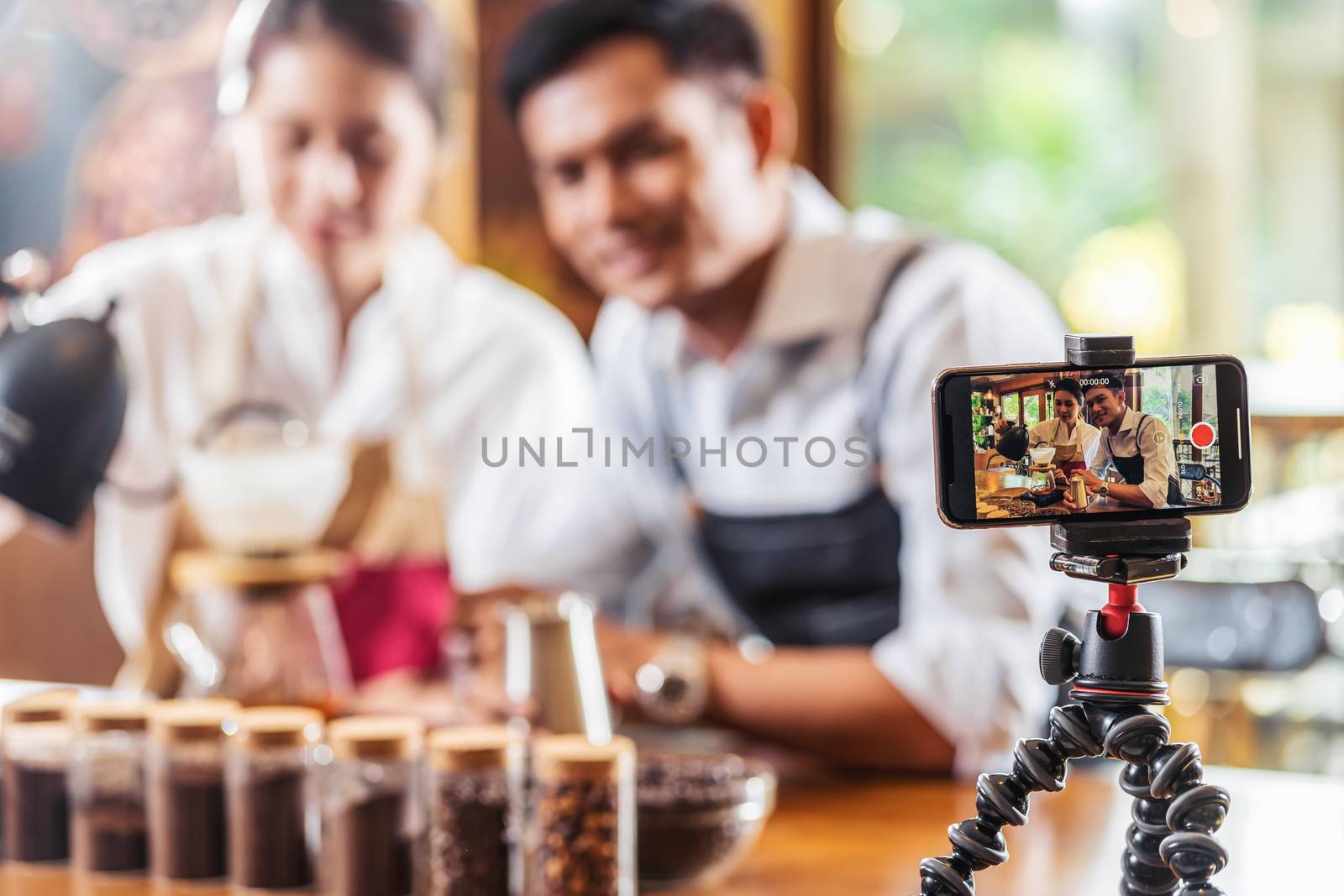 Mobile phone taking Video to two Asian Barista presenting a cup of coffee, dripping coffee show to audience in coffee shop,making espresso and americano, Small business owner and startup concept