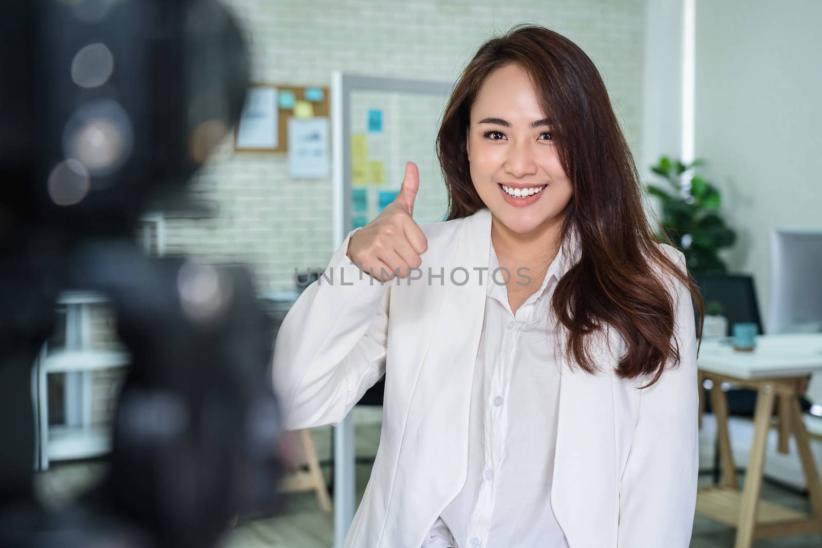 Portrait of Asian Business woman with thumbs up like when record by Tzido