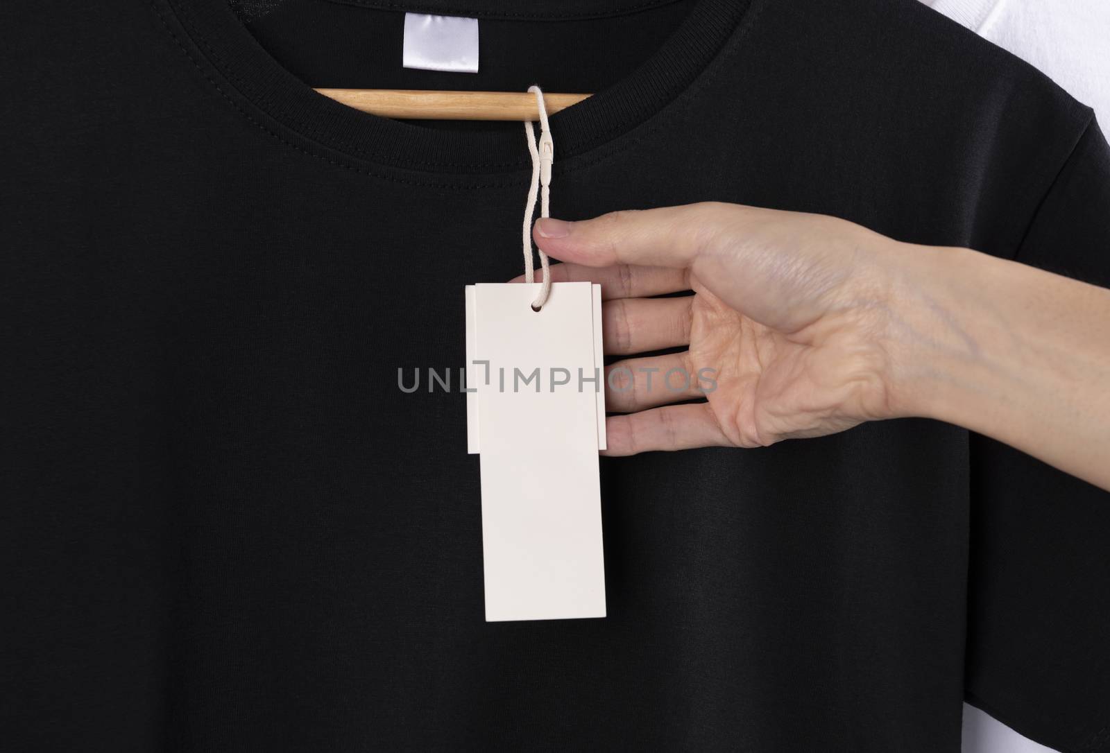 Mockup blank black t-shirt and blank label tag for advertising. by barameeyay