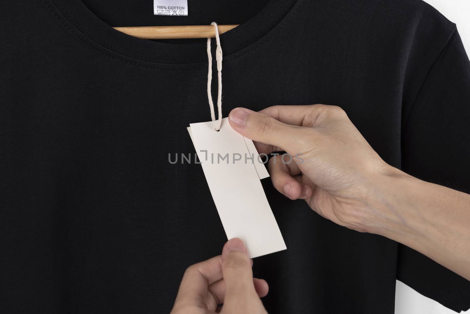 Mockup blank black t-shirt and blank label tag for advertising.