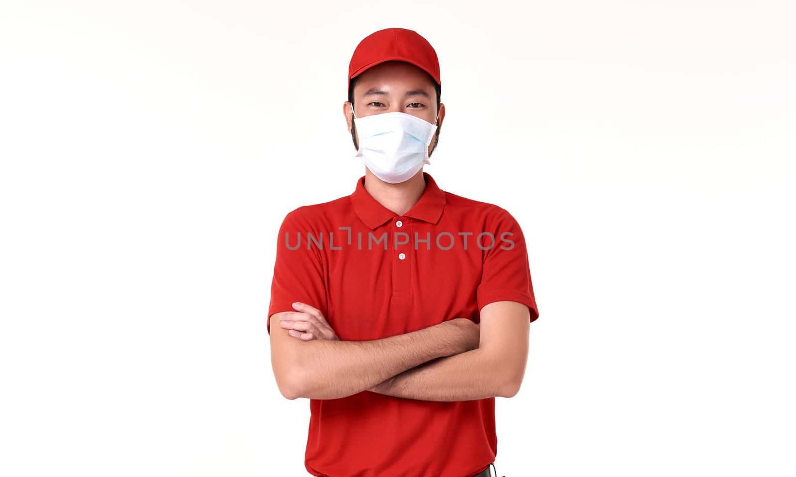 Asian delivery man wearing face mask in red uniform isolated over white background. by barameeyay