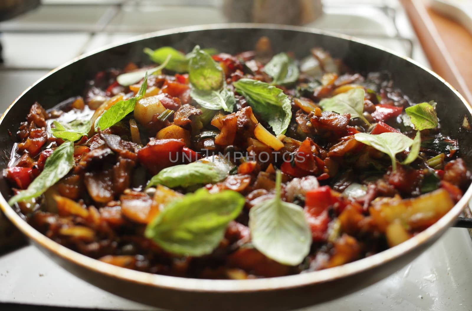 Healthy food vegetables are fried in a pan Tomato eggplant onion pepper zucchini by selinsmo