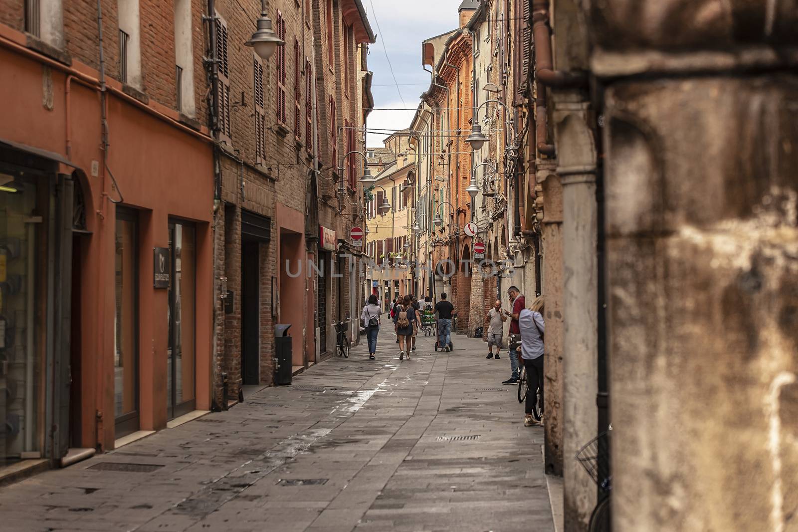 FERRARA, ITALY 29 JULY 2020 : Alley of Ferrara in Italy full of people walking
