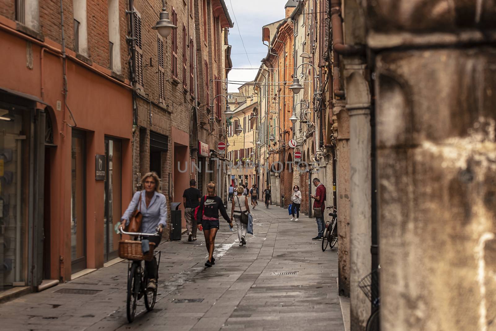Alley of Ferrara in Italy full of people walking 2 by pippocarlot