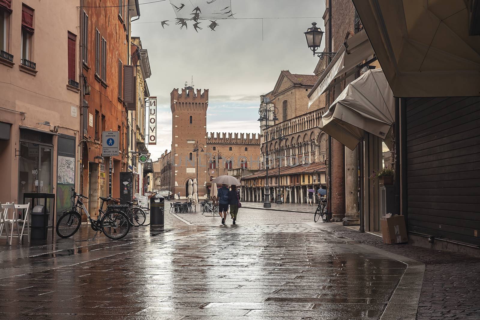 Ferrara alley with a view of the castle and the main square by pippocarlot