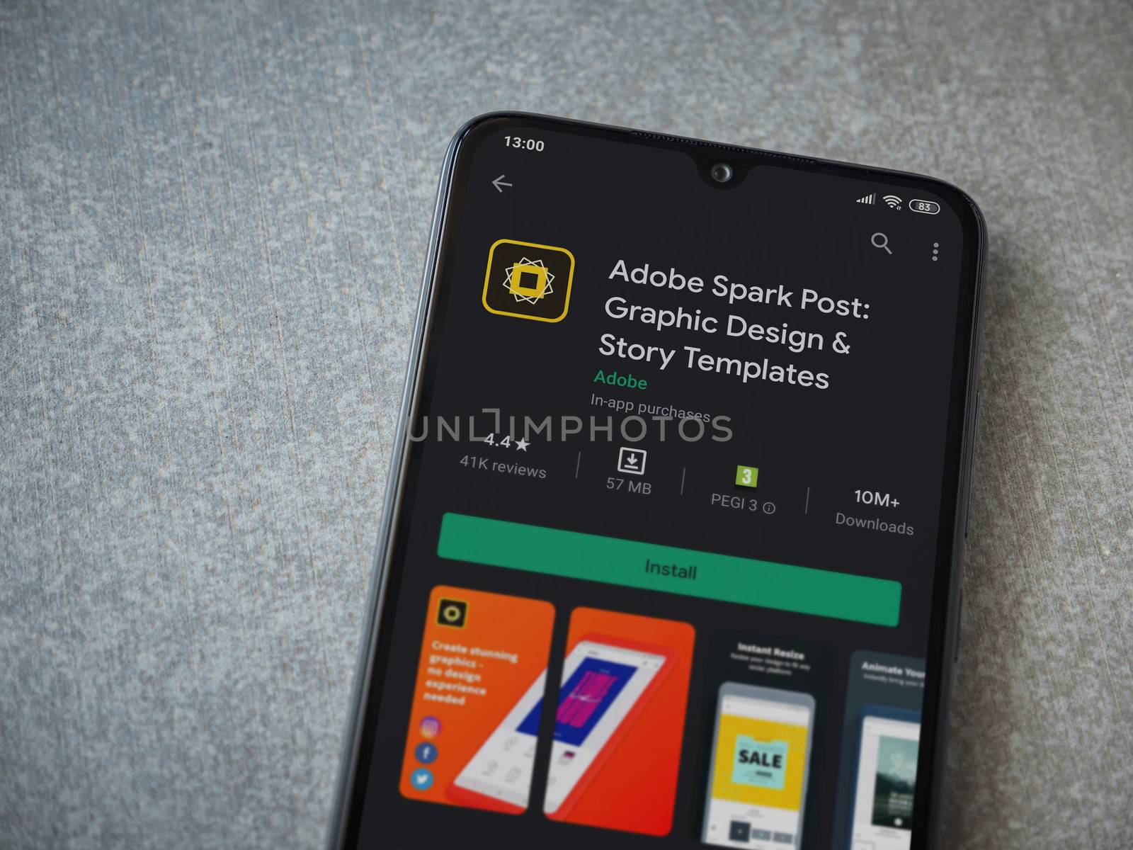 Lod, Israel - July 8, 2020: Adobe Spark Post - Graphic Design and Story Templates app play store page on the display of a black mobile smartphone on ceramic stone background.Top view flat lay with copy space