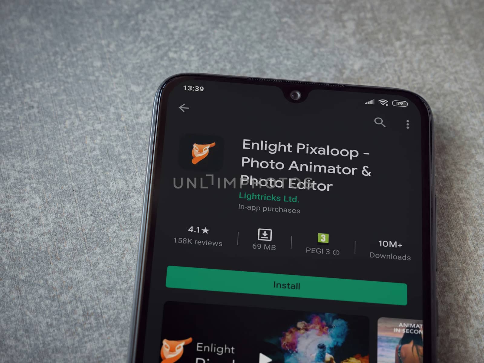 Lod, Israel - July 8, 2020: Enlight Pixaloop app play store page on the display of a black mobile smartphone on ceramic stone background. Top view flat lay with copy space.