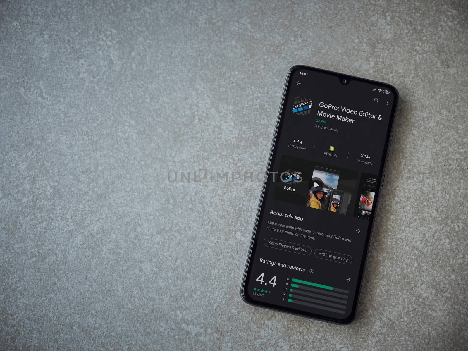 Lod, Israel - July 8, 2020: GoPro - Video Editor and Movie Maker app play store page on the display of a black mobile smartphone on ceramic stone background. Top view flat lay with copy space.