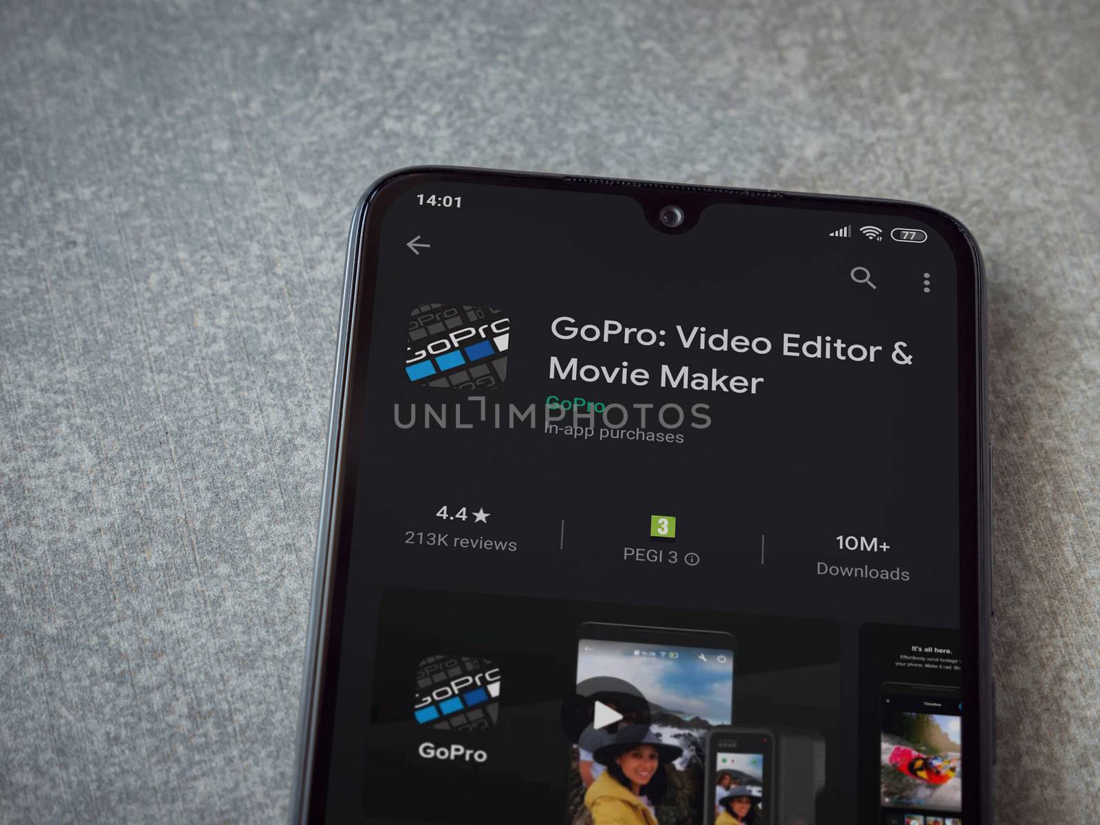 Lod, Israel - July 8, 2020: GoPro - Video Editor and Movie Maker app play store page on the display of a black mobile smartphone on ceramic stone background. Top view flat lay with copy space.