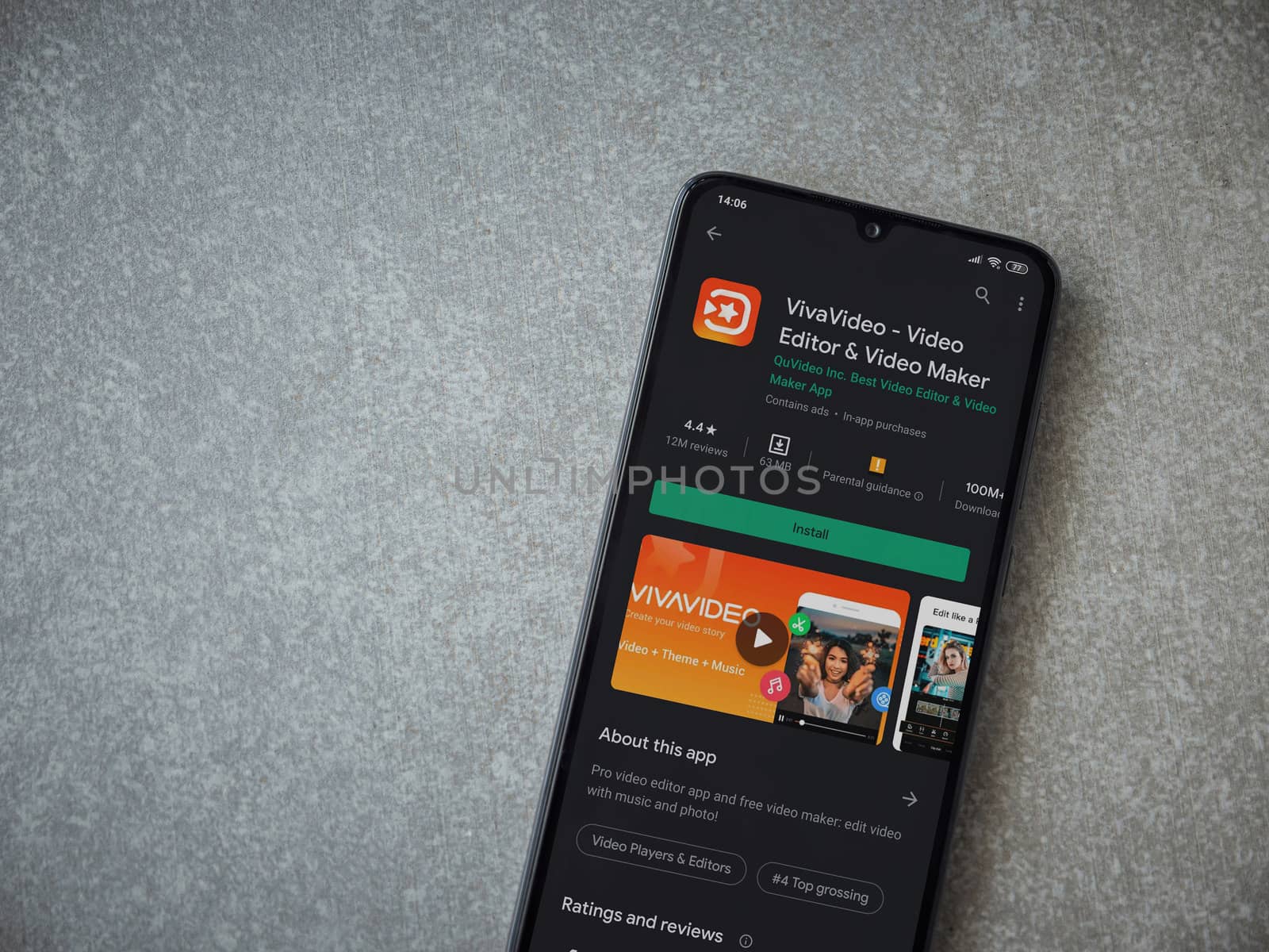 Lod, Israel - July 8, 2020: VivaVideo - Video Editor and Movie Maker app play store page on the display of a black mobile smartphone on ceramic stone background. Top view flat lay with copy space.