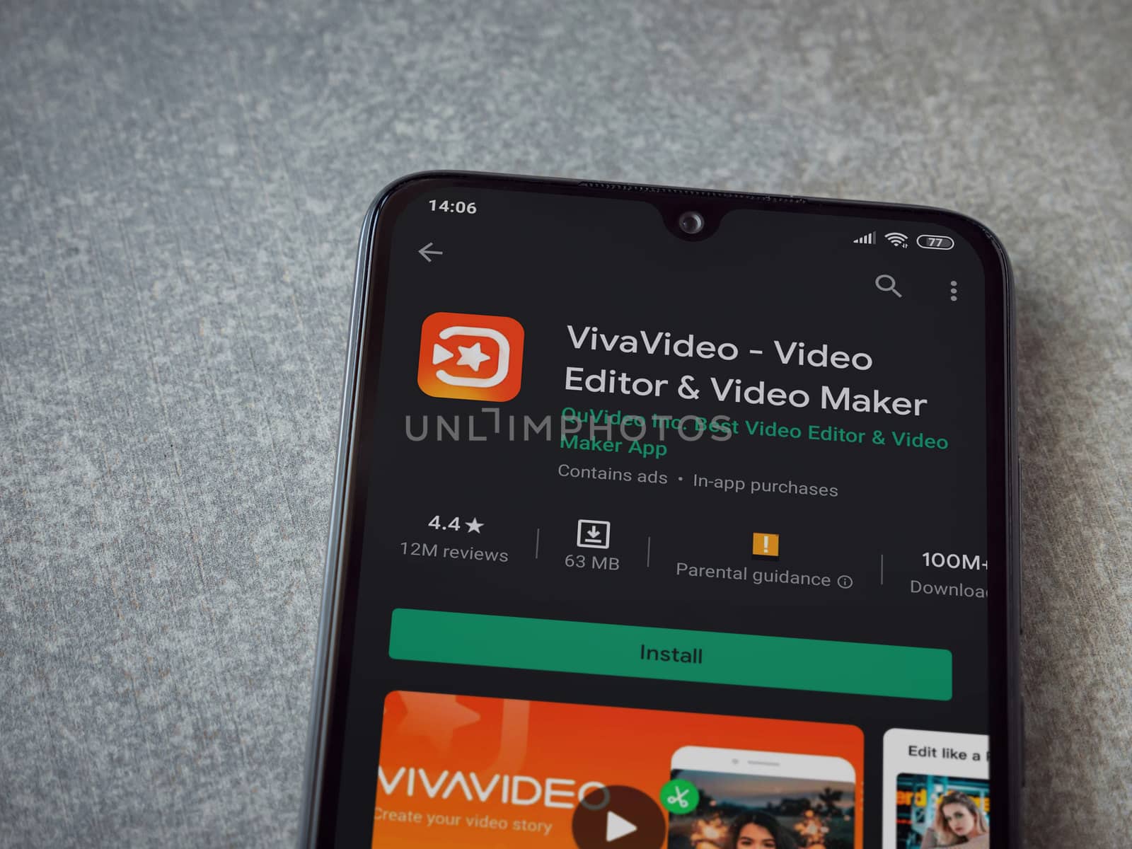 Lod, Israel - July 8, 2020: VivaVideo - Video Editor and Movie Maker app play store page on the display of a black mobile smartphone on ceramic stone background. Top view flat lay with copy space.