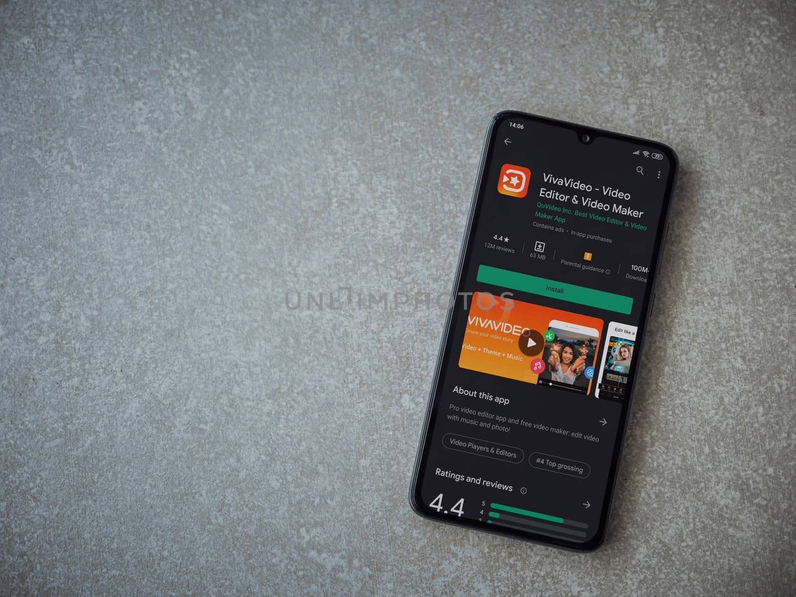 Lod, Israel - July 8, 2020: VivaVideo - Video Editor and Movie Maker app play store page on the display of a black mobile smartphone on ceramic stone background. Top view flat lay with copy space.