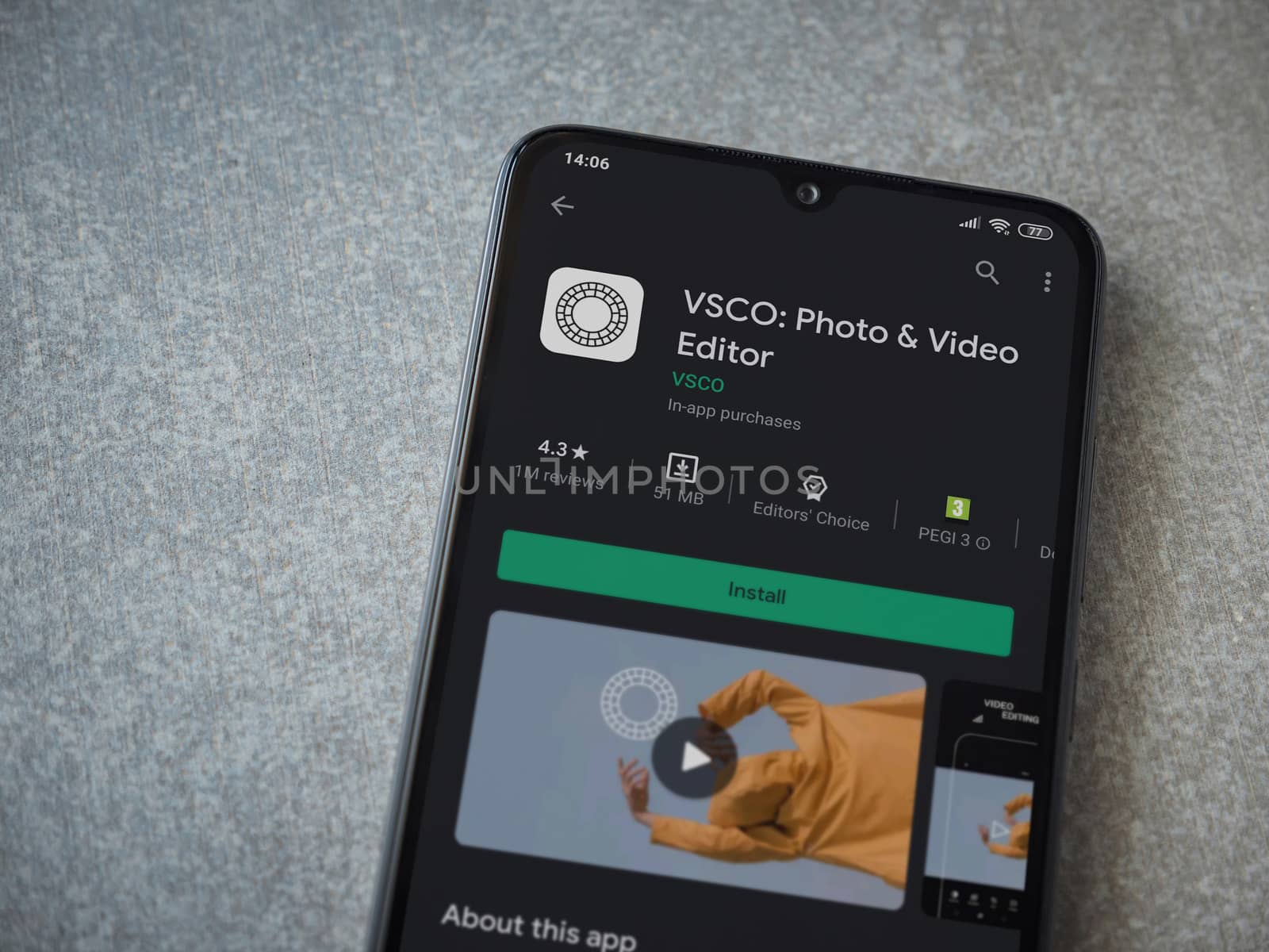Lod, Israel - July 8, 2020: VSCO - Photo and Video Editor app play store page on the display of a black mobile smartphone on ceramic stone background. Top view flat lay with copy space. 