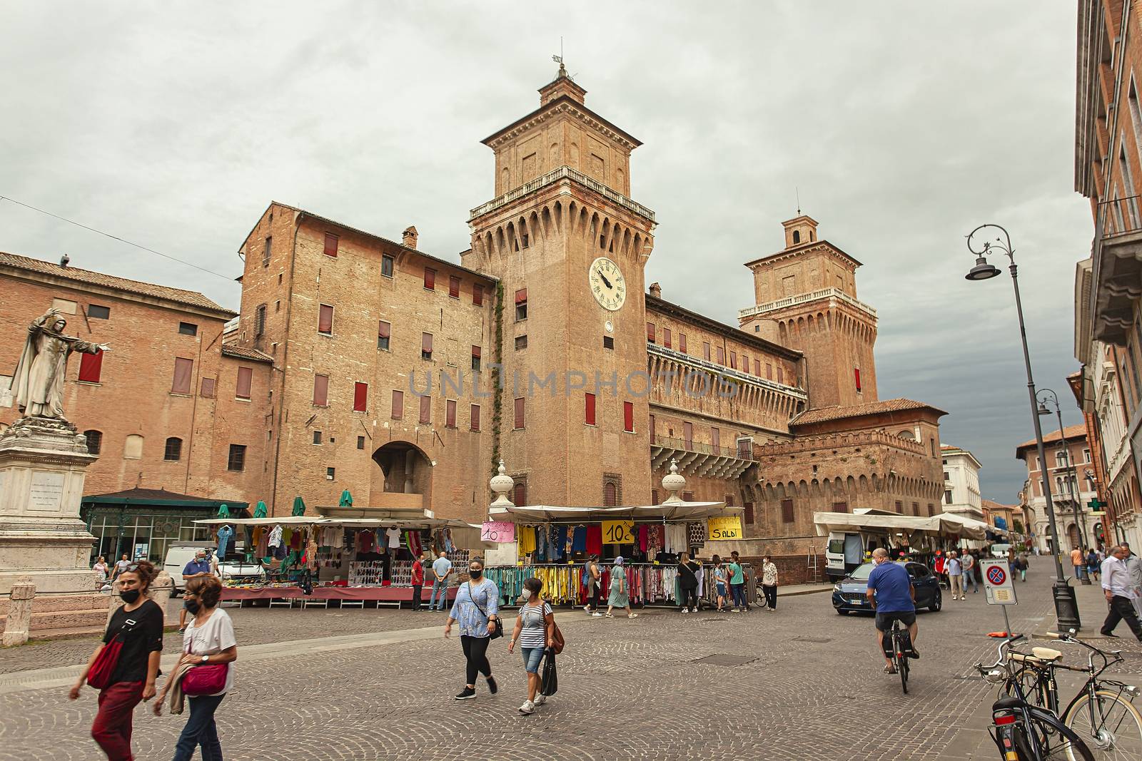 FERRARA, ITALY 29 JULY 2020 : View of the castle of Ferrara of three quarters with people strolling in front of it