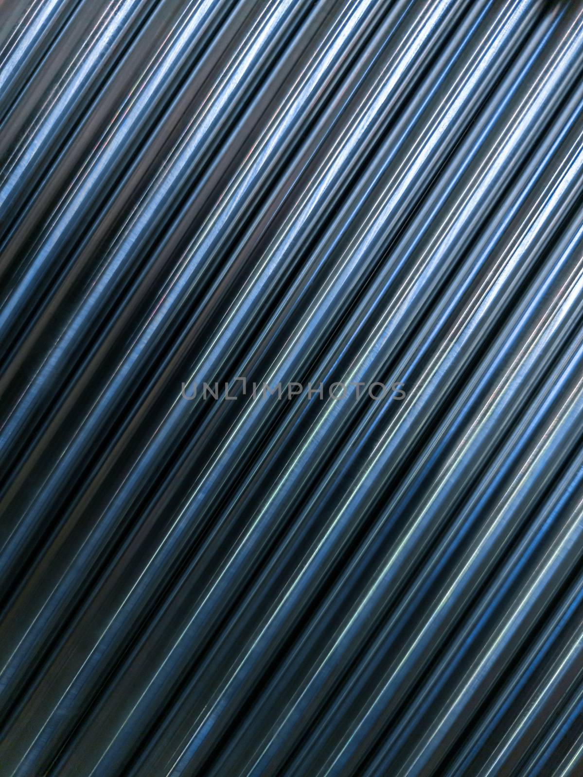 abstract industrial background of many shiny cnc turned rods with flat lay diagonal geometric composition by z1b