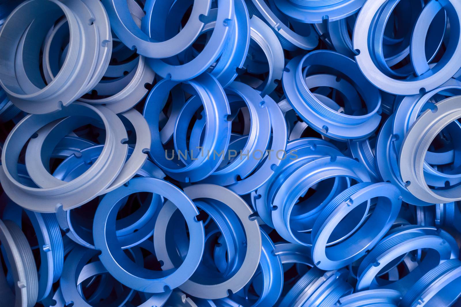 an abstract background of classic blue color coated metal ring parts.