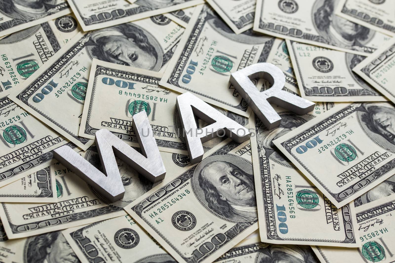 a word war laid by metal letters on dollar banknotes background - for military business concept