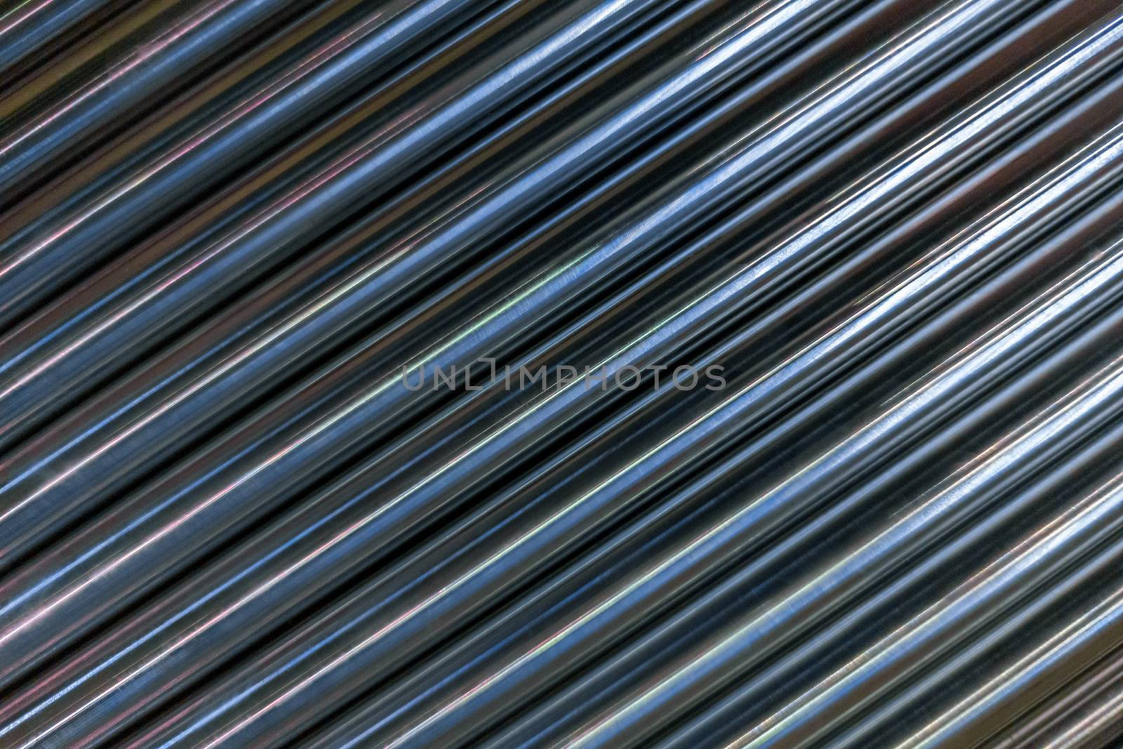abstract industrial background of shiny cnc turned rods with flat lay in simple diagonal geometric composition