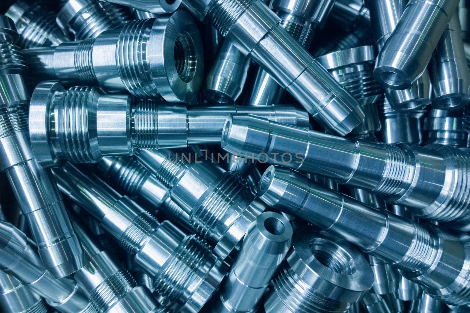 shiny steel parts background, a pile of long steel rods after modern fine cnc turning cut.