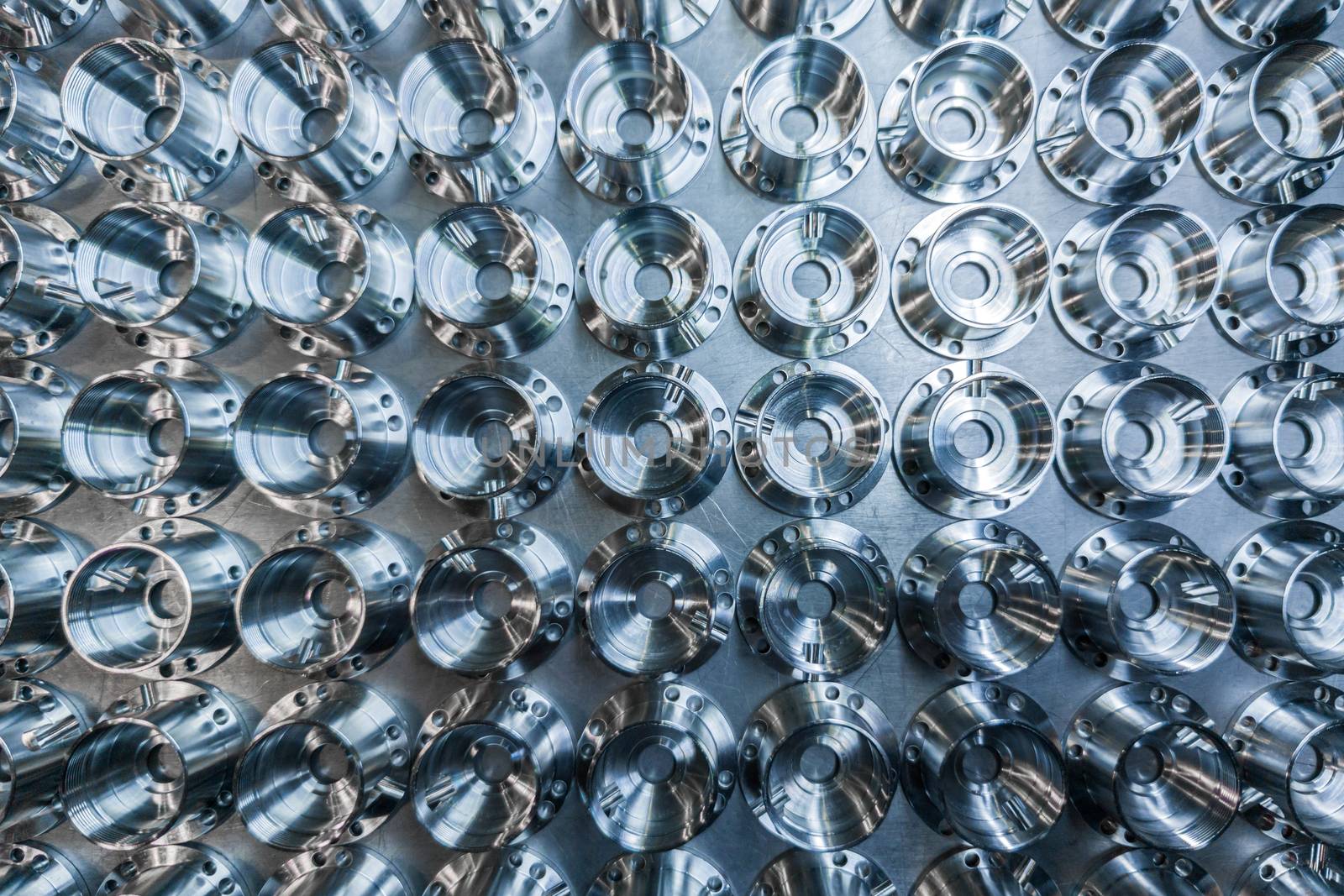 a batch of shiny metal cnc aerospace parts production - close-up flat lay with selective focus for industrial background in flat lay composition