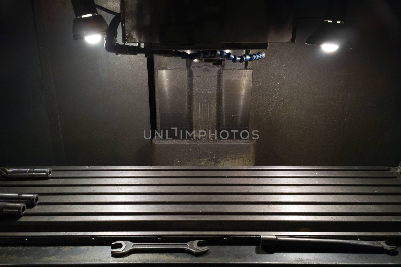 old manual milling machine in noir lighting style closeup with selective focus.